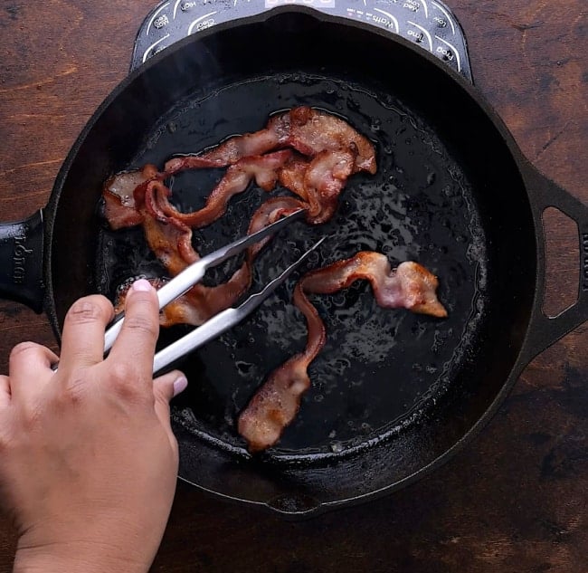 Bacon cooking in skillet.