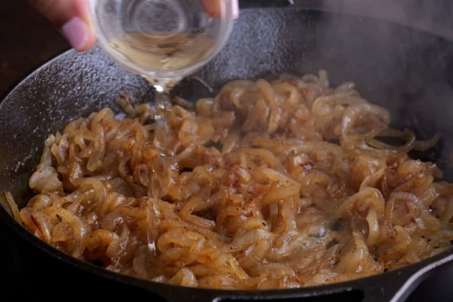 Sherry being added to pan.