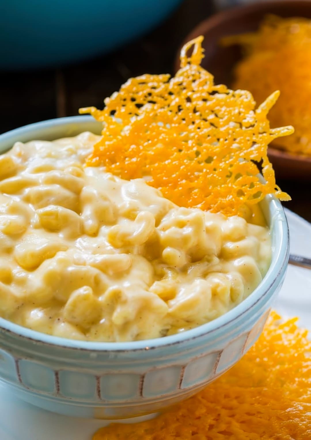 Mac and cheese in bowl with cheese crisps.