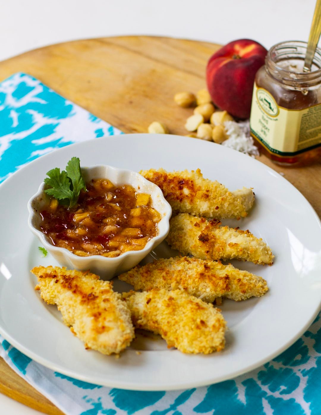 Coconut Macadamia Chicken Tenders on plate with dipping sauce.