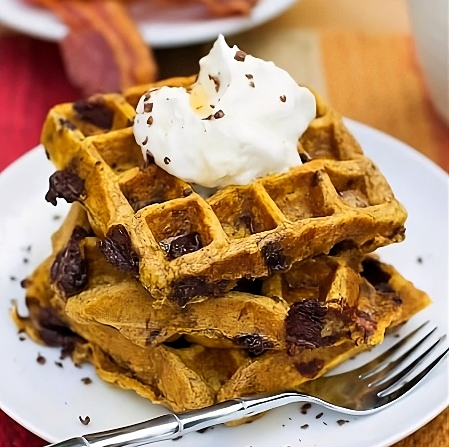 Pumpkin Waffles topped with whipped cream.