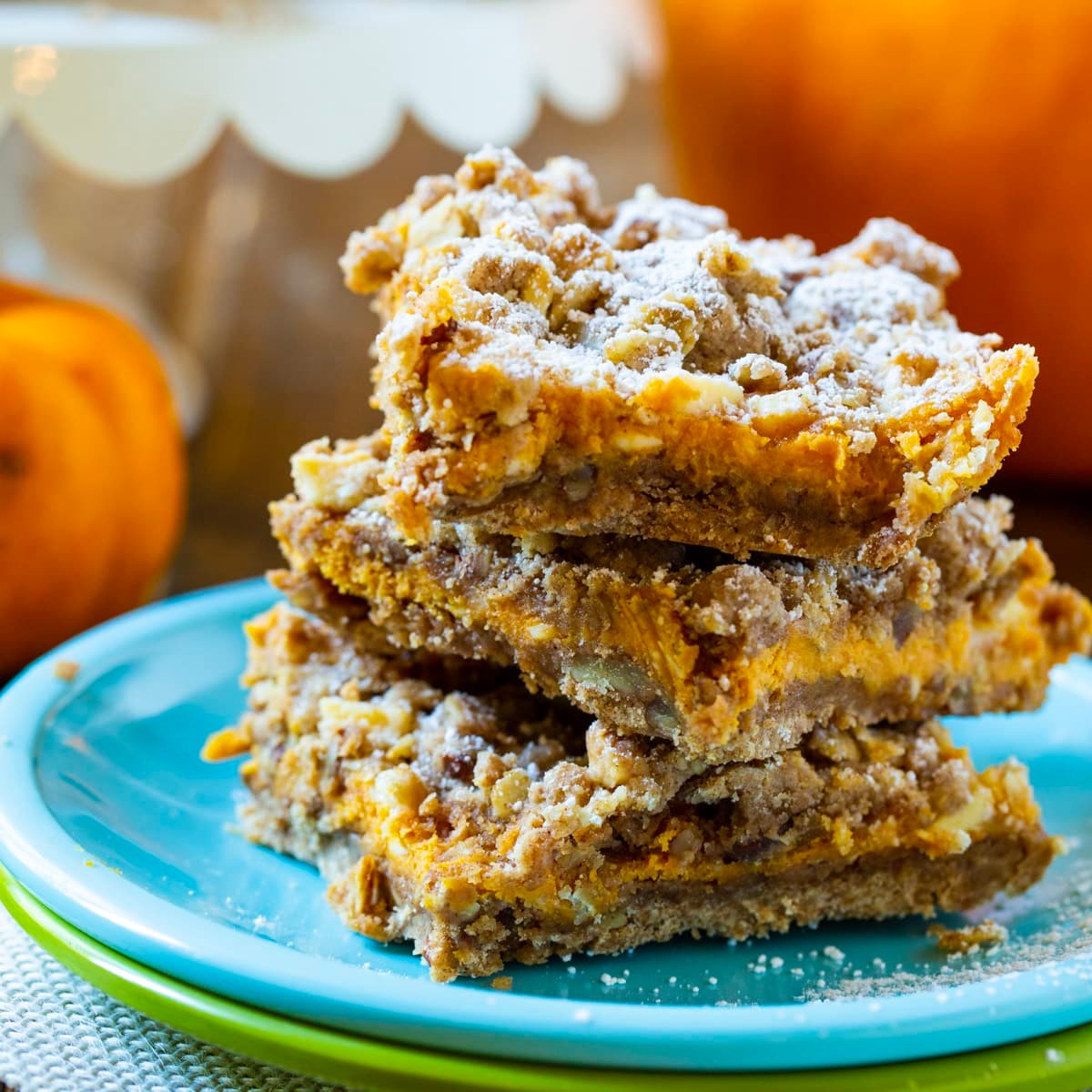 Pumpkin Spice Bars stacked on a plate.