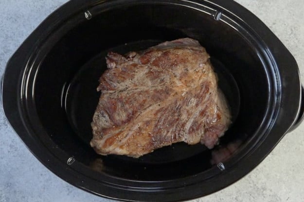 Roast placed in slow cooker.