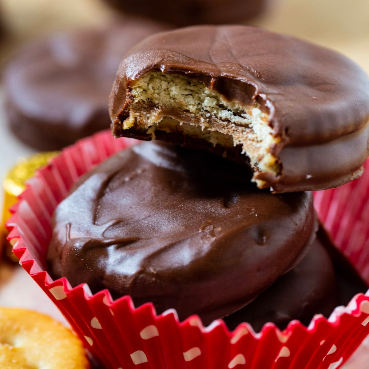 Three Rolo Stuffed Ritz Crackers stacked connected  apical  of each   other.