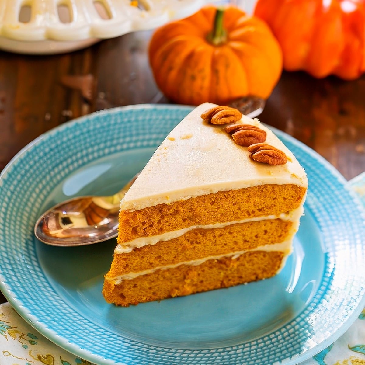 Slice of Butterscotch Pumpkin Cake on a blue plate.