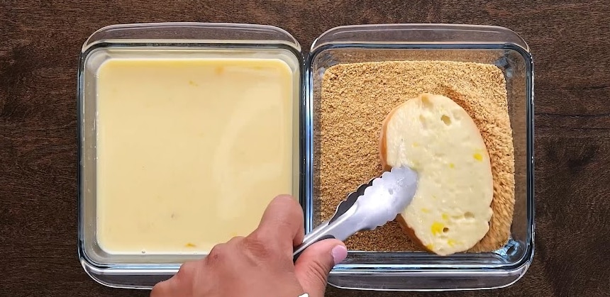 Dipping bread in graham cracker crumbs.