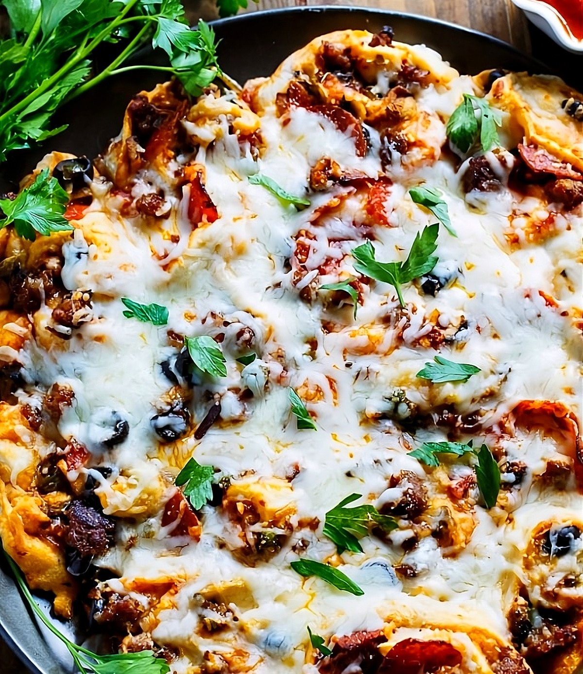 Pull-Apart Supreme Pizza Pinwheels on a pizza pan.