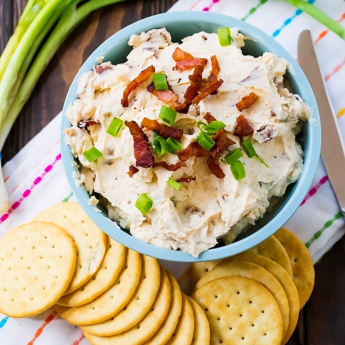 Bacon Horseradish Spread in a bowl surrounded by crackers.