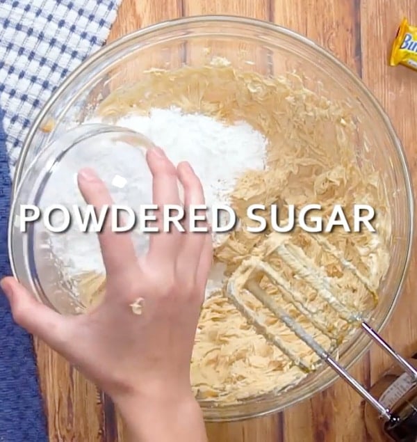 Adding powdered sugar.