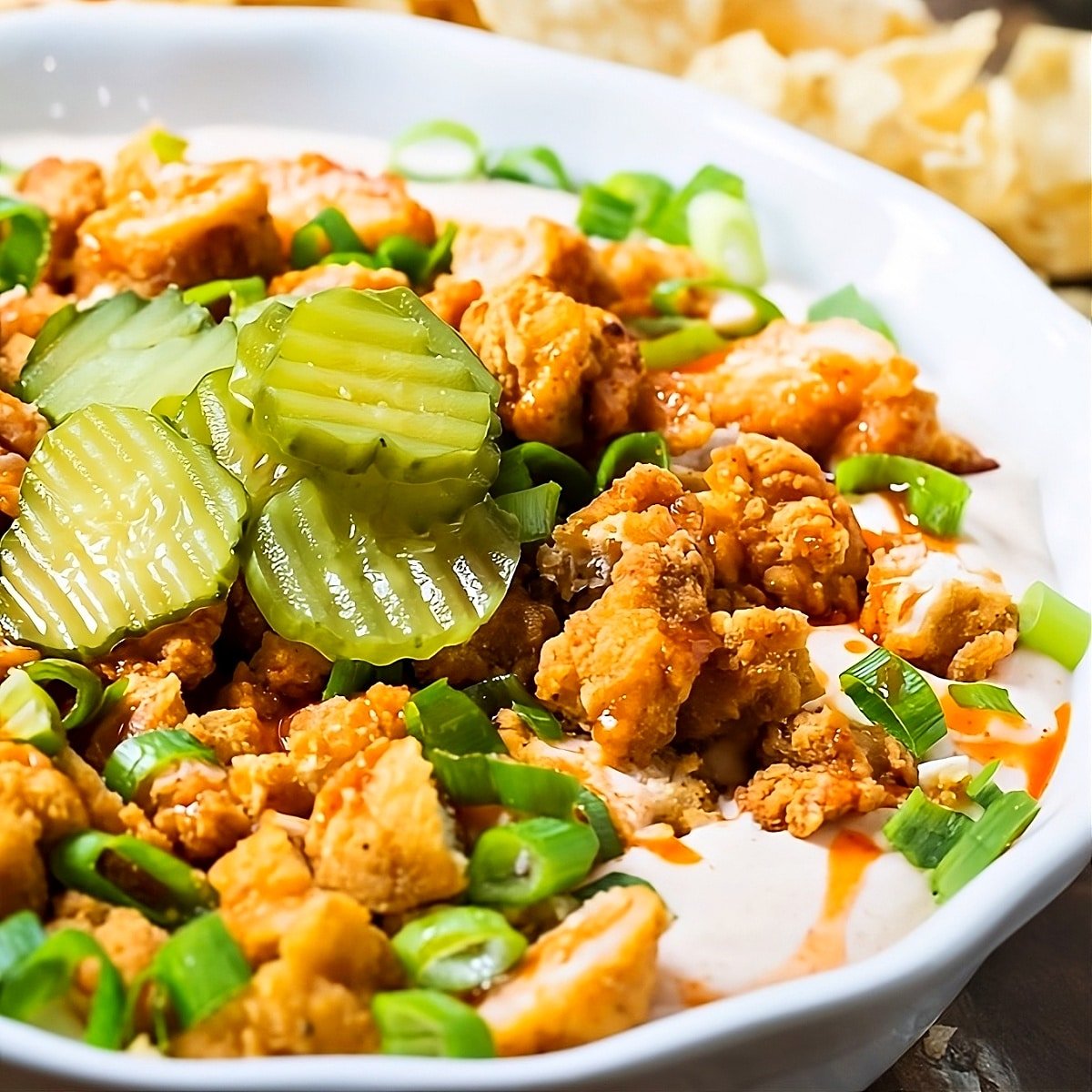 Nashville Hot Chicken Dip topped with pickle slices.