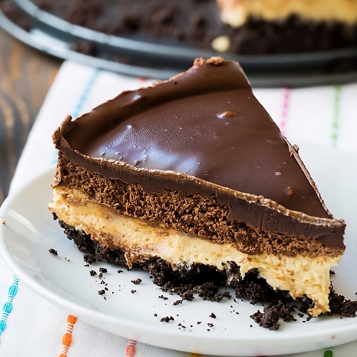 Slice of Chocolate and Peanut Butter Mousse Cheesecake on a plate.