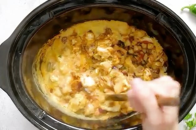 Stirring the ingredients halfway through cooking.