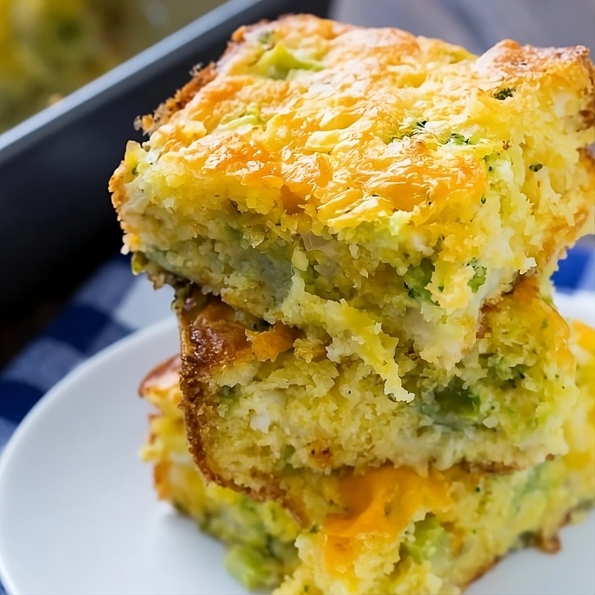 Cheesy Broccoli Cornbread stacked on a plate.