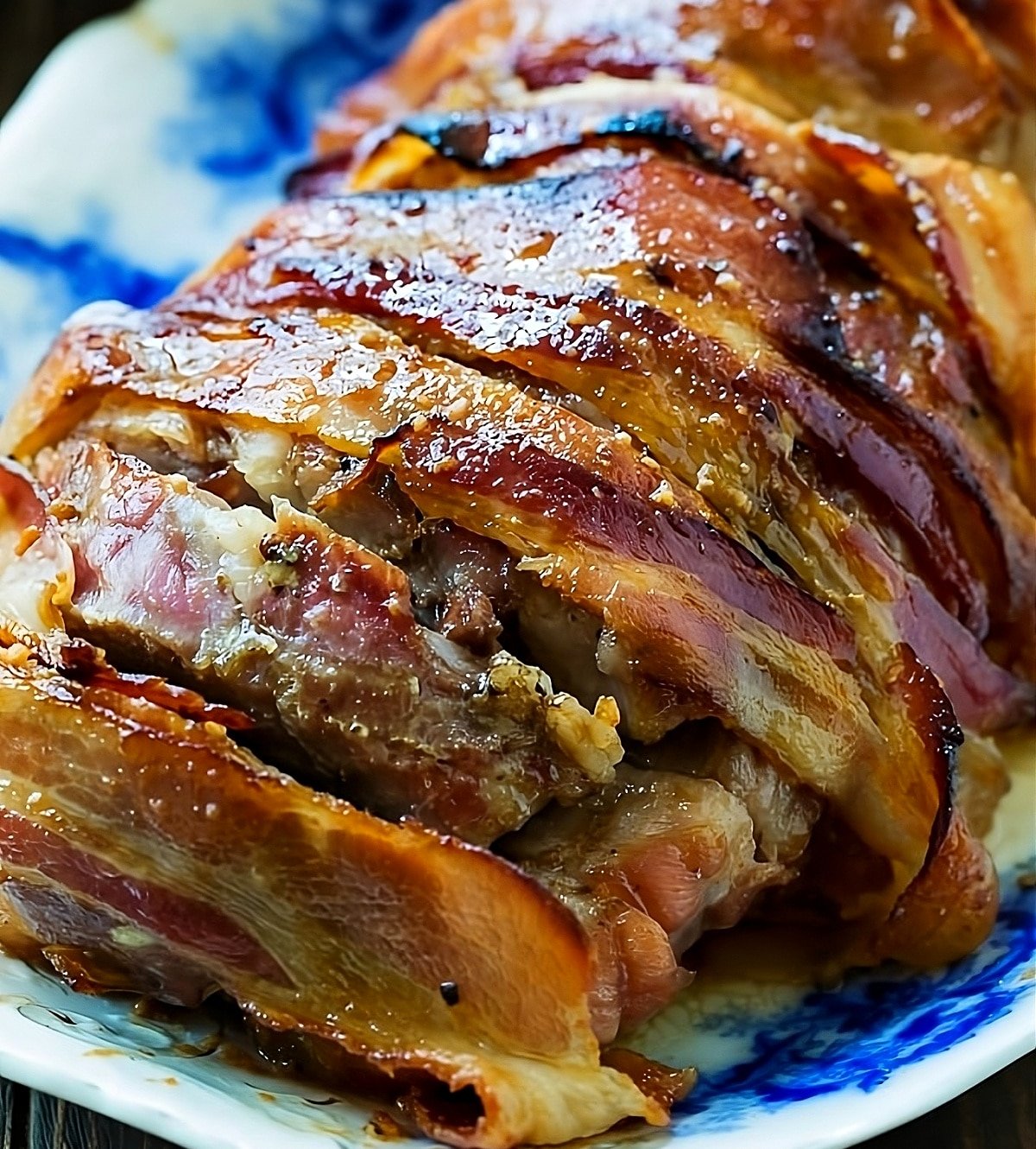 Bacon Wrapped Maple Glazed Pork Loin cut into slices.