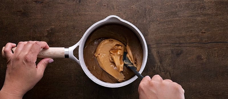 Stirring in the peanut butter.