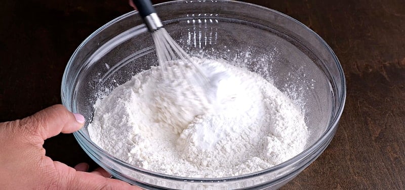 Whisking dry ingredients together.