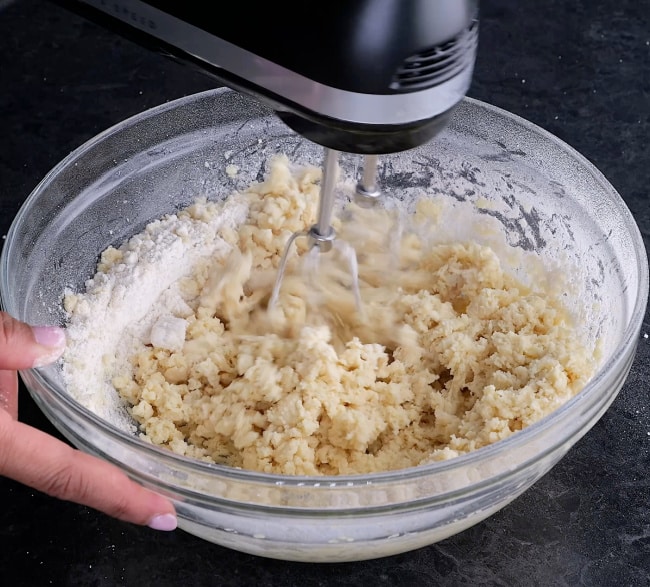 Mixing flour into dough.