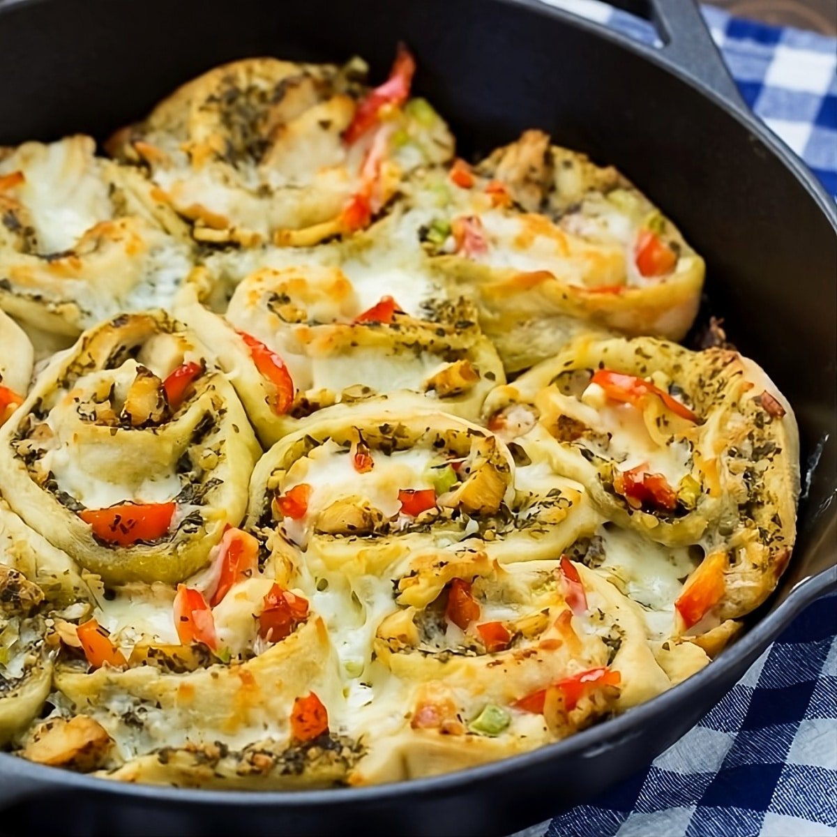 Chicken Pesto Pizza Rolls in a cast iron pan.