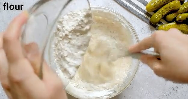 Adding flour to batter.