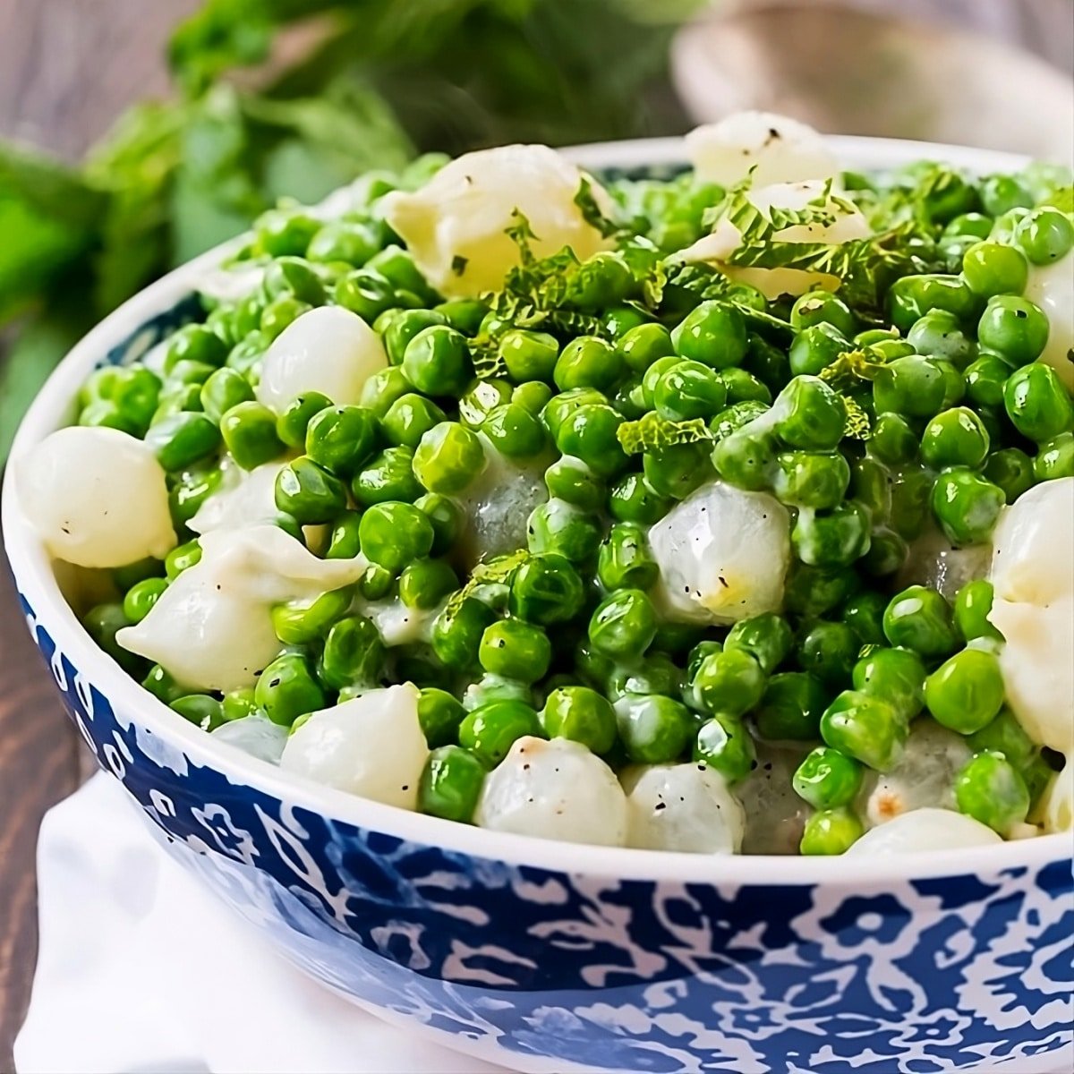 Creamed Peas and Pearl Onions in a serving bowl.