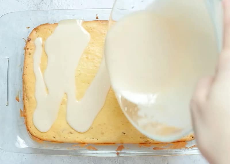 Glaze being poured on cake.