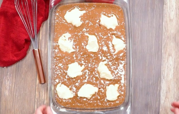 Dollops of cream cheese over batter.
