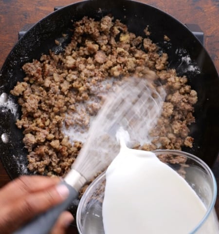 Whisking in the milk.