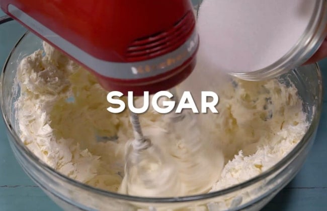 Mixing in the sugar.
