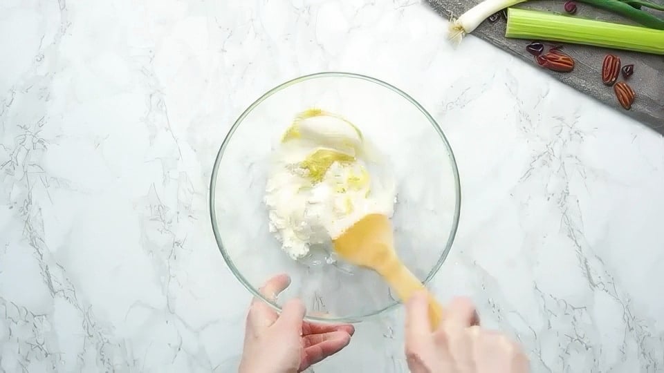 Mixing together cream cheese, mayo, and mustard.