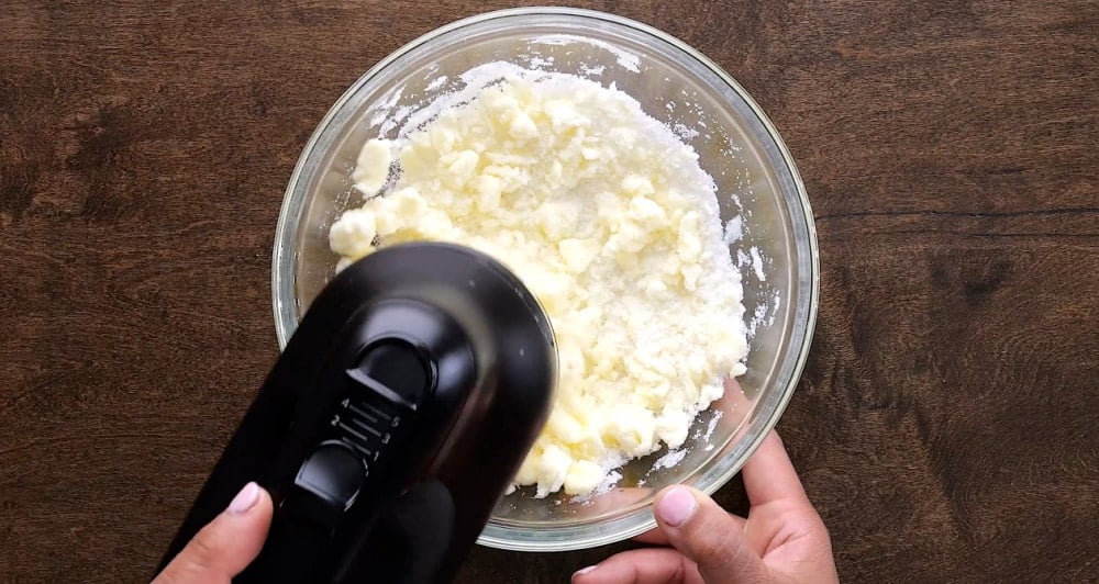 Beating butter and sugar with electric mixer.