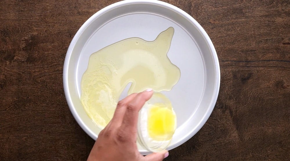 Melted butter poured into cake pan.