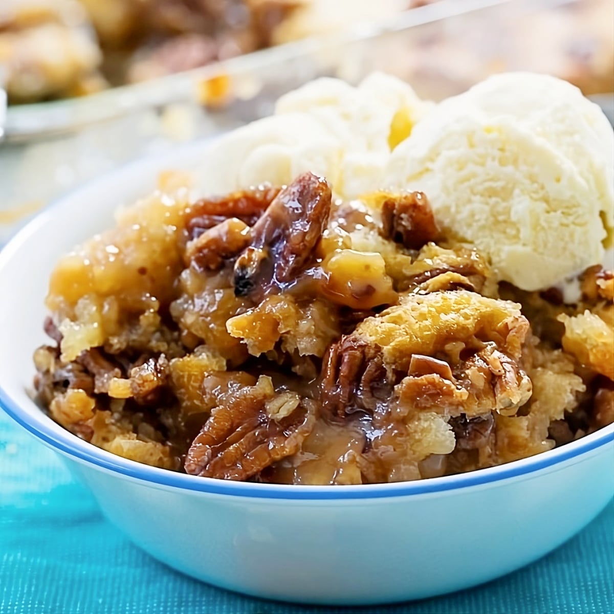 Pecan Pie Cobbler topped with ice cream.