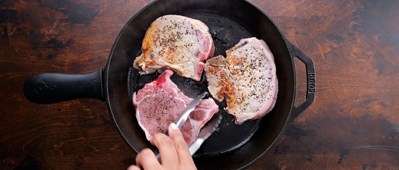 Browning the pork chops.