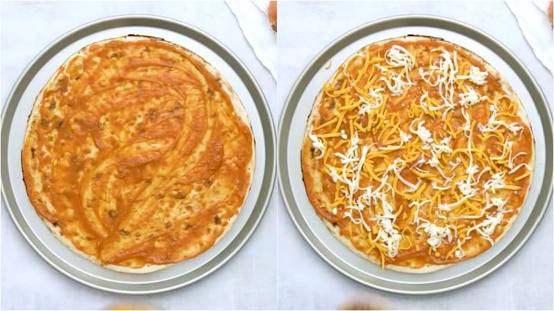Sauce and cheese added to pizza.