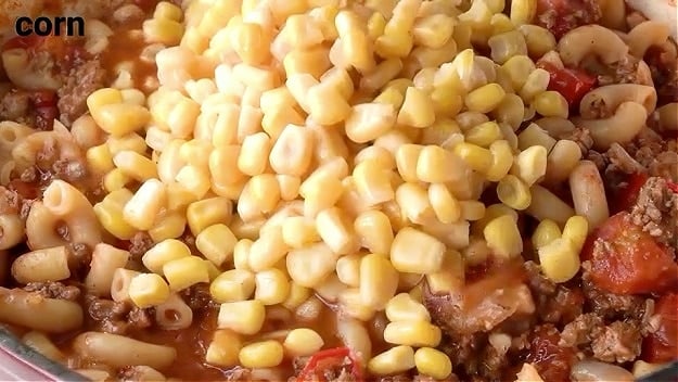 Adding corn.