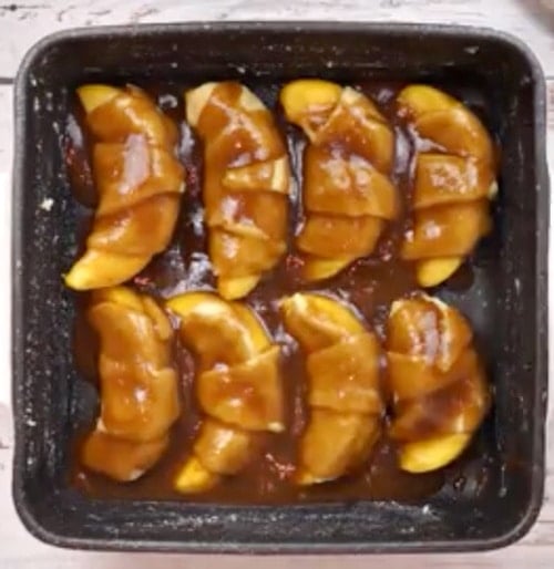 Butter mixture spooned over crescents.