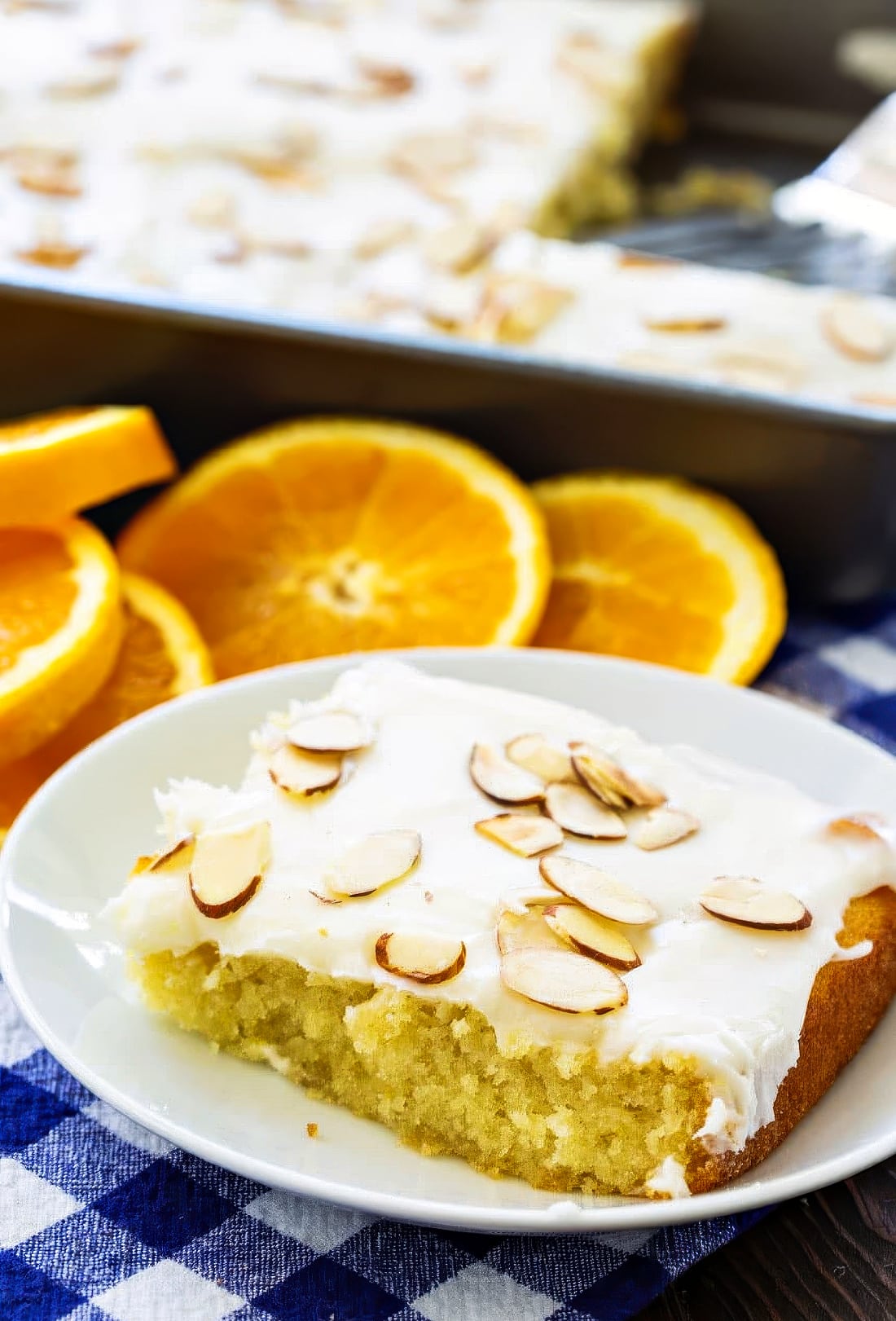 Square of Orange sheet cake on a small plate.