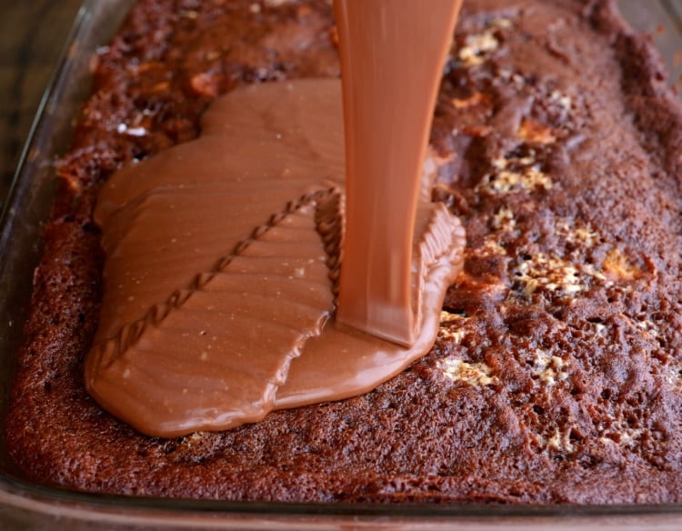 Frosting being poured on cake.