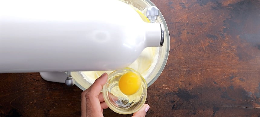 Mixing in the eggs.