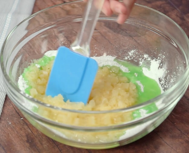 Mixing pineapple and pudding mix.