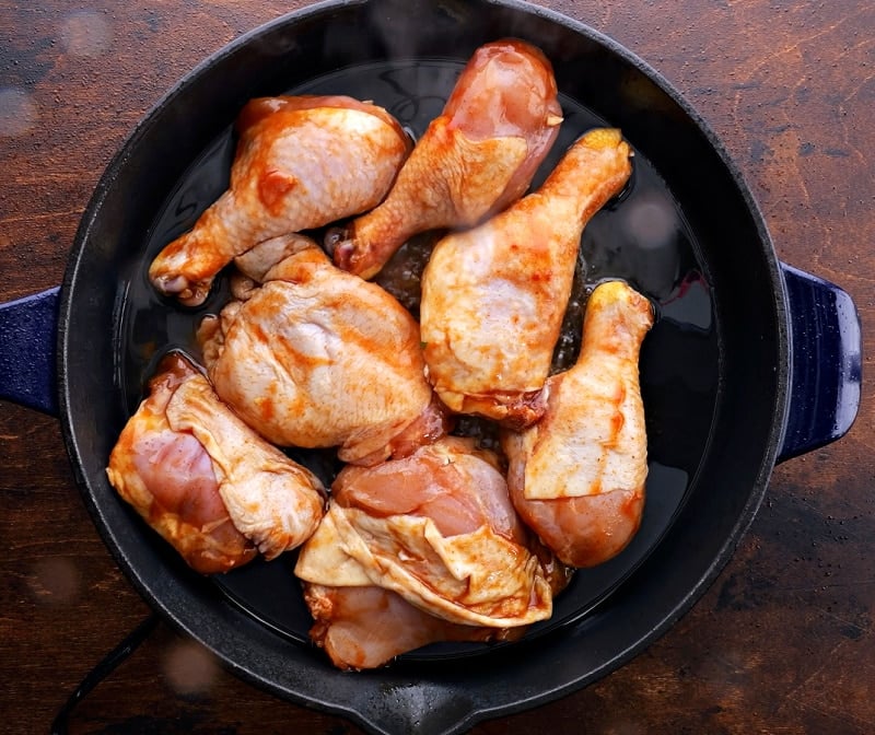 Chicken placed in pan.