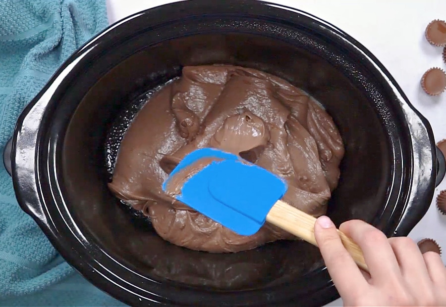 Batter being spread in slow cooker.