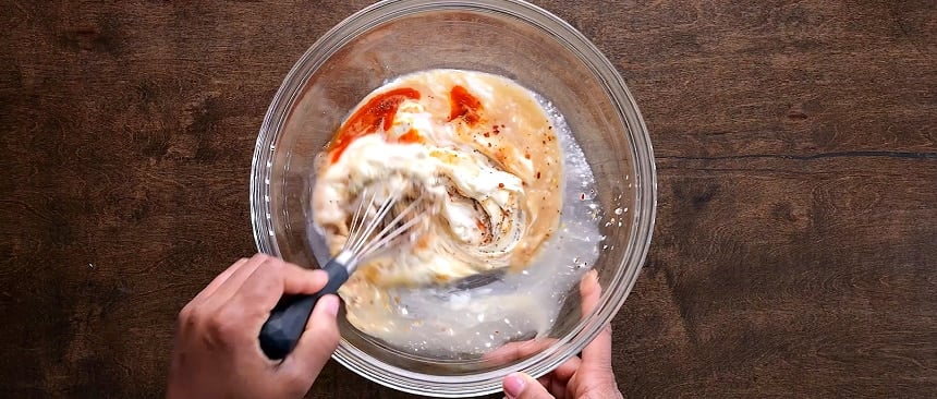 Mixing the dressing.