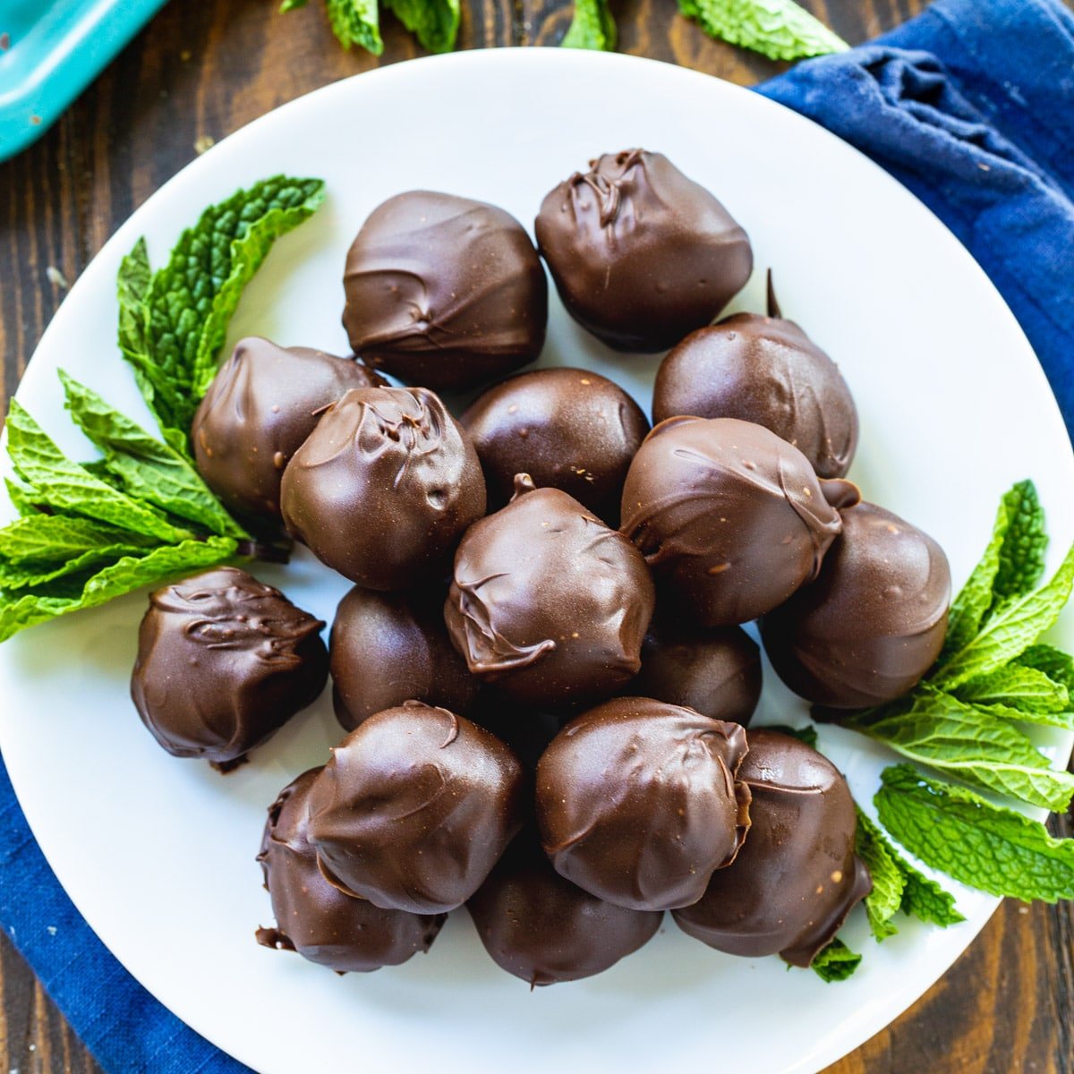 Creme de Menthe Truffles on a plate with fresh mint.