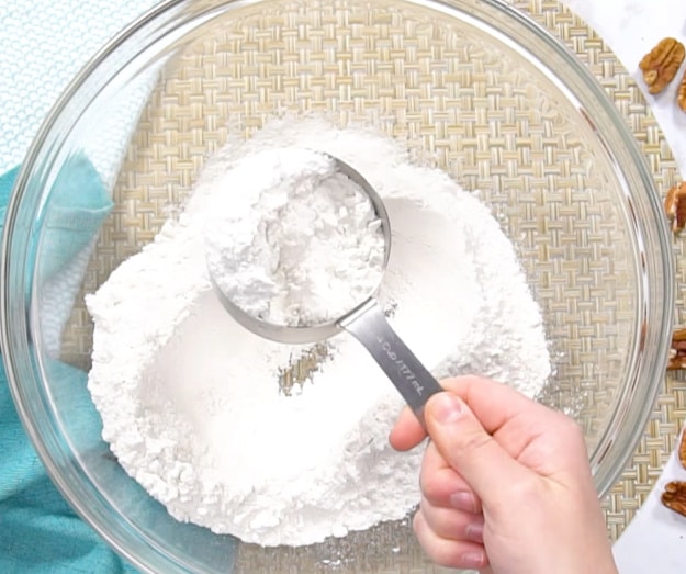 Measuring out cake mix.