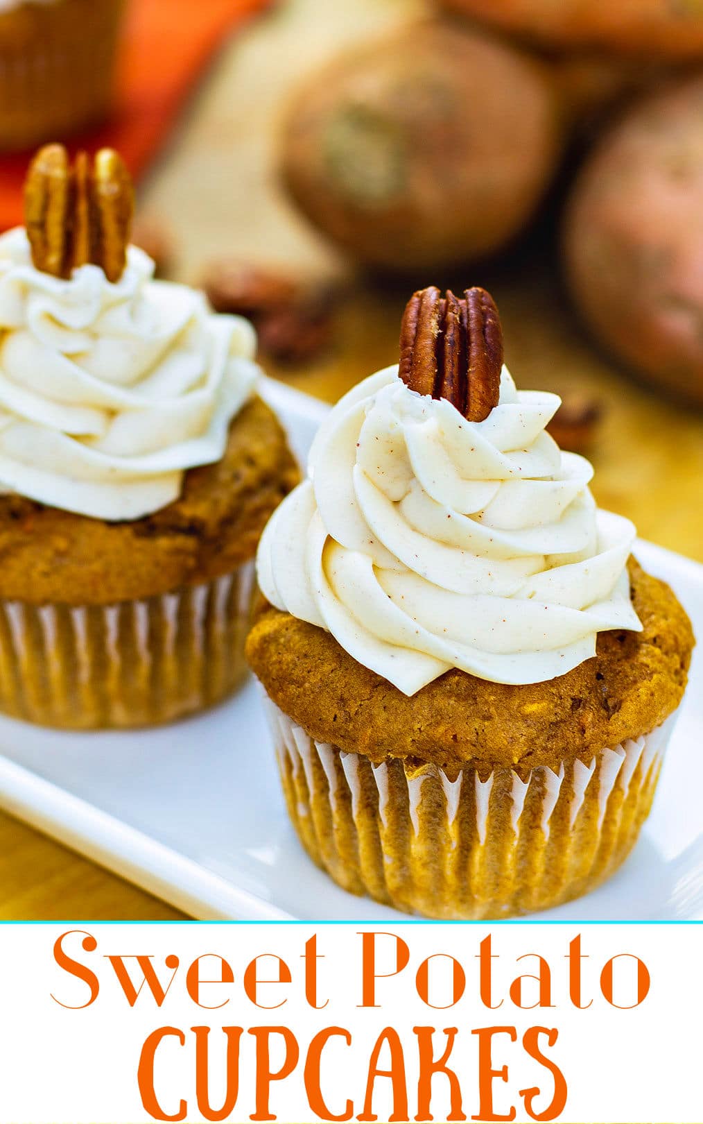 Close-up of cupcake with frosting topped with a pecan.