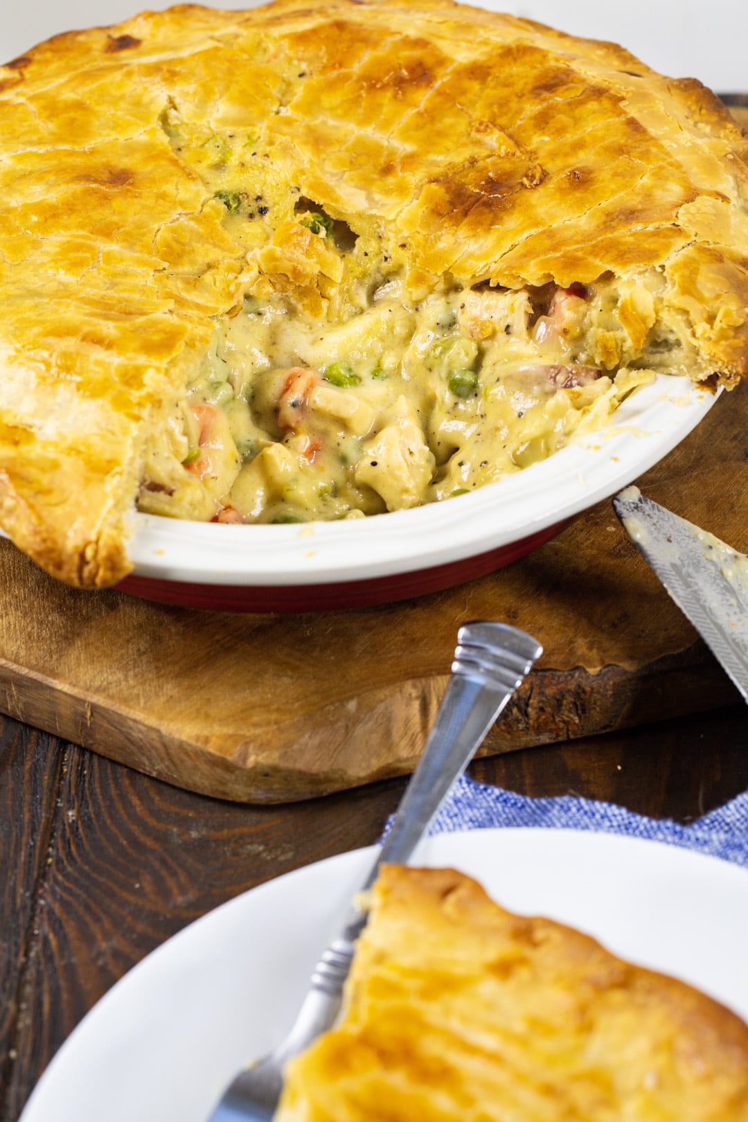 Cheesy Chicken Pot Pie in a pie pan with a slice cut out.