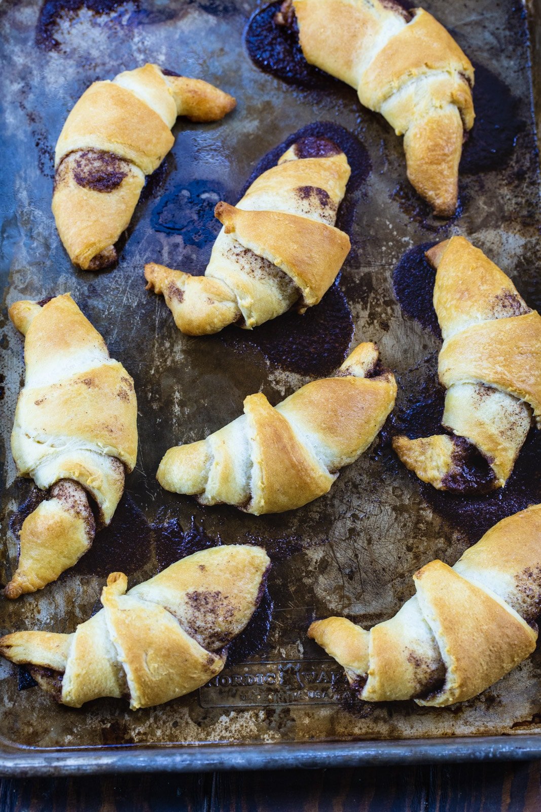 Cooked crescents on a baking sheet.