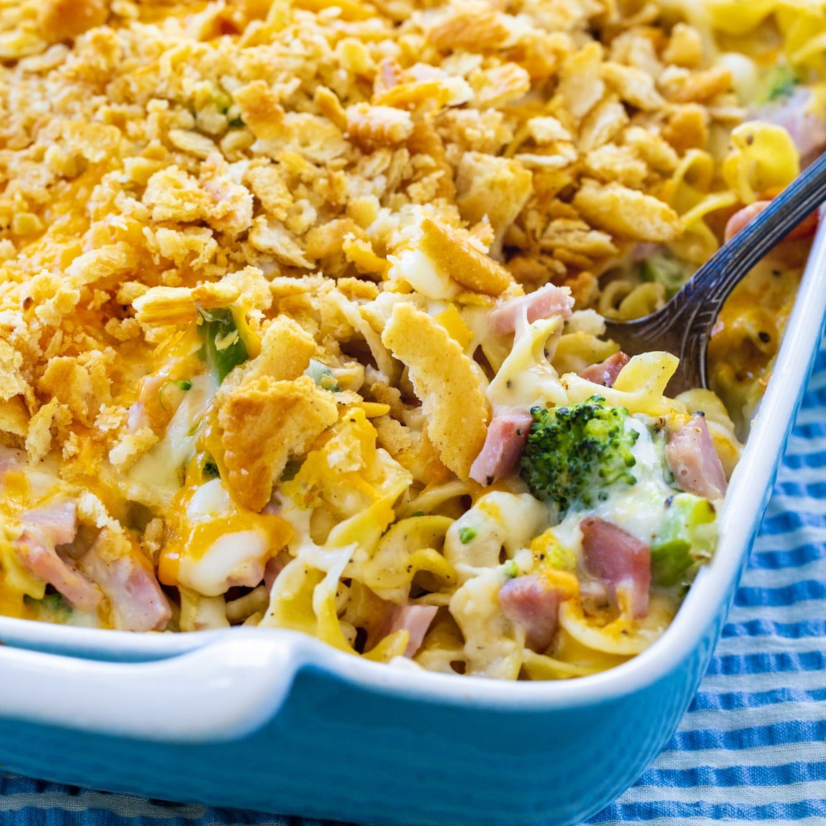 Spoon scooping up Ham and Noodle Casserole with Broccoli.