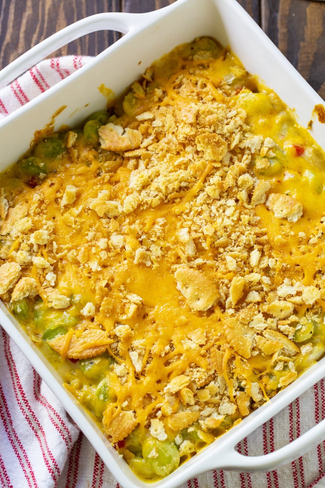 Lima Bean Casserole topped with cheddar cheese and crushed Ritz cracker topping.